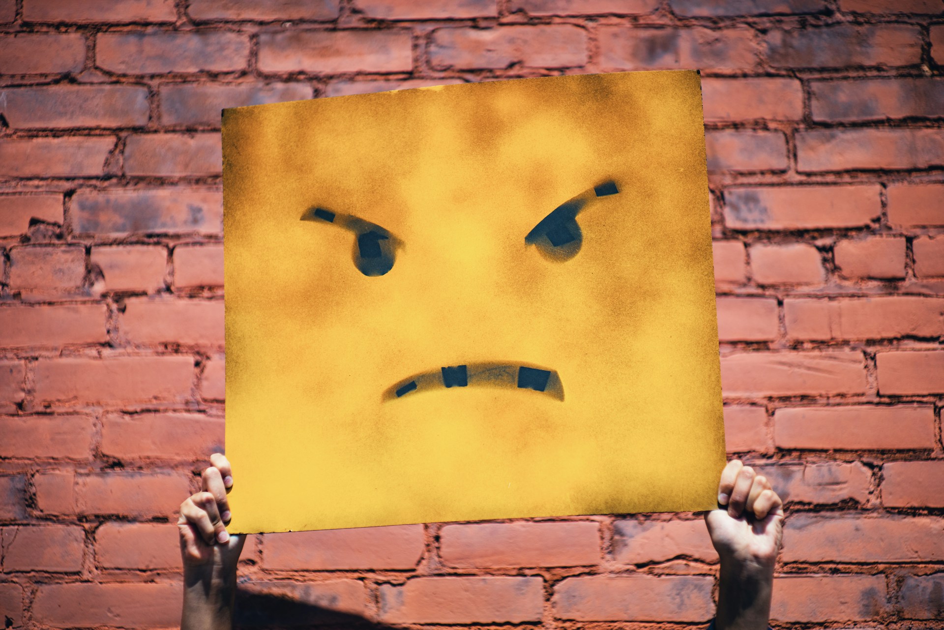 Picture of an irritated face on a board, because this article is about 4 things we hate about web agencies. So WE'RE irritated!