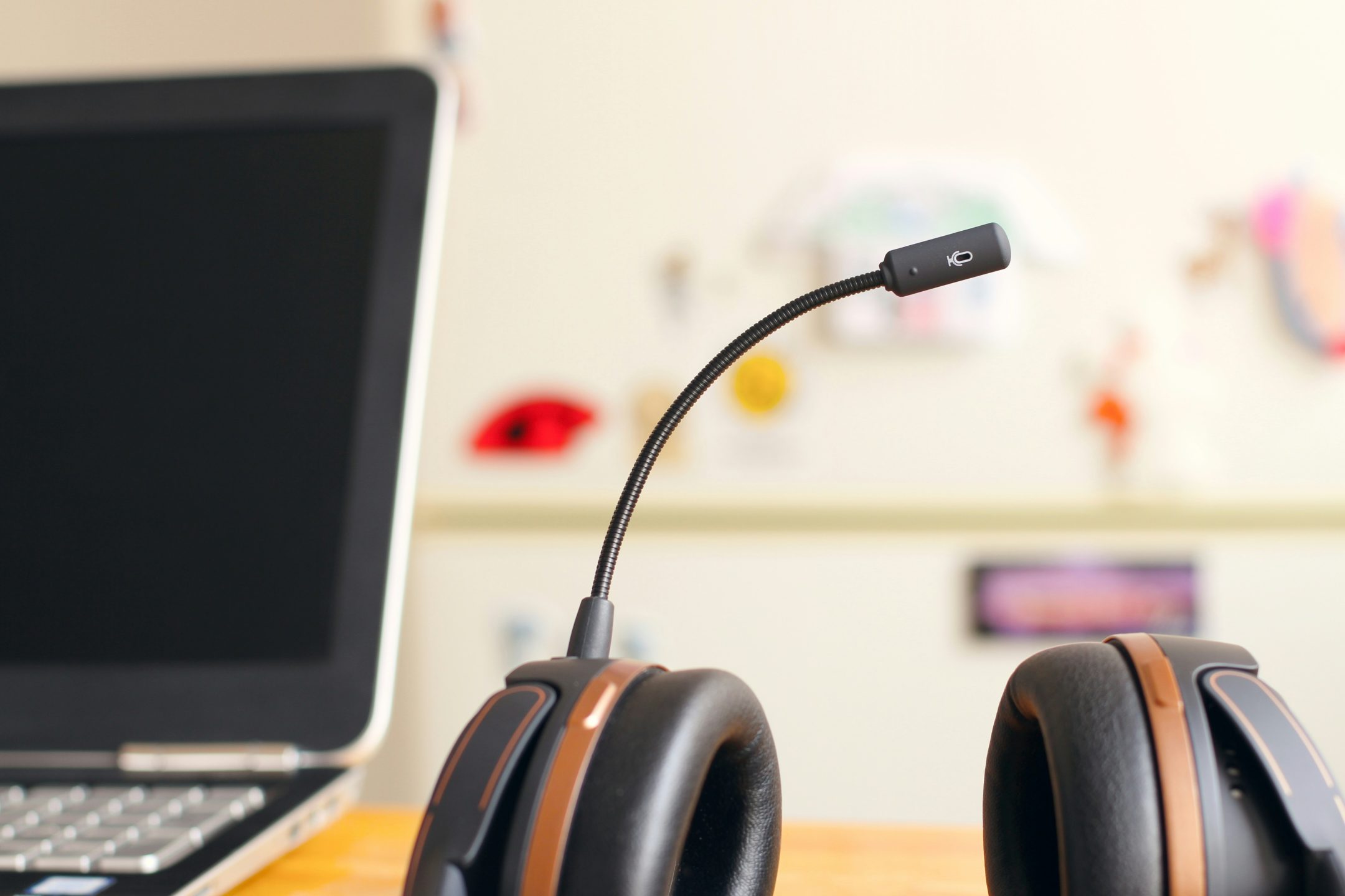 Picture of black and brown headset near laptop computer to illustrate 5 pros and cons of Freshdesk