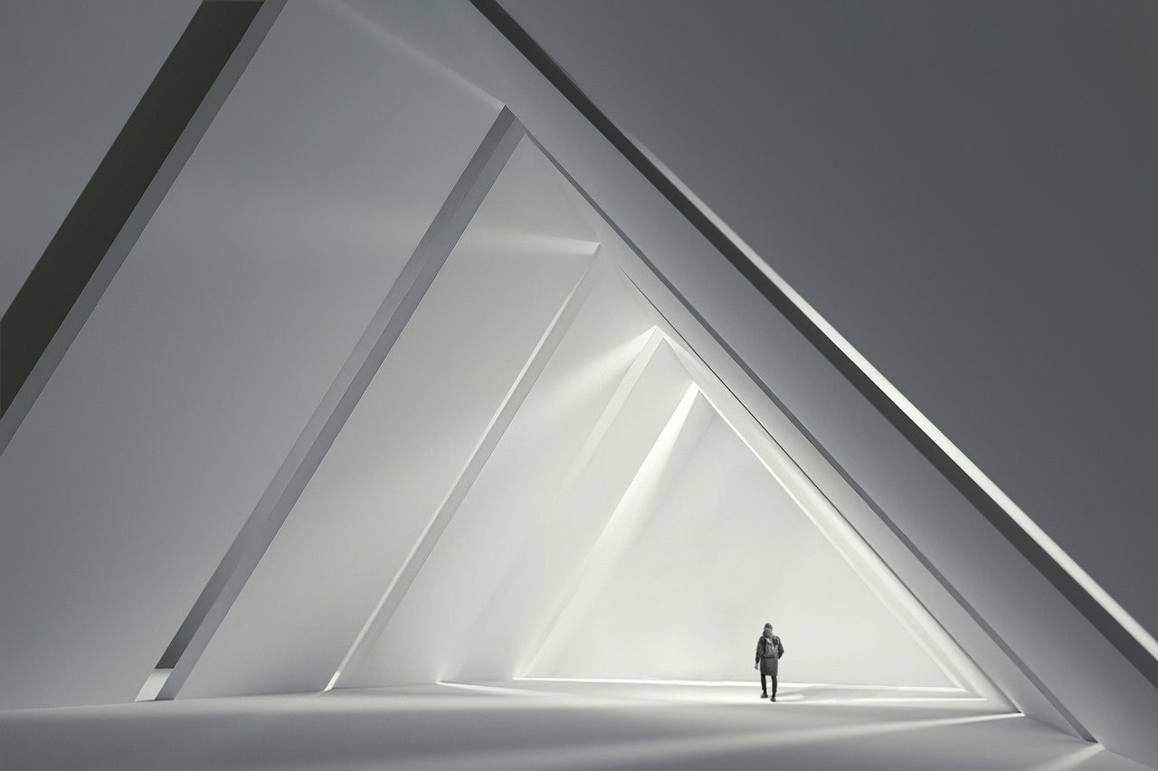 Picture of a person walking in a white corridor shaped like a triangle. Lots of white space. Like how white space on your website is super important.